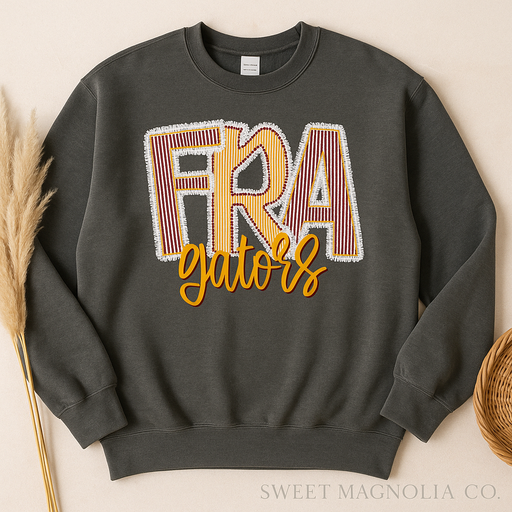 Dark gray sweatshirt with 'FRA gators' text on a beige background