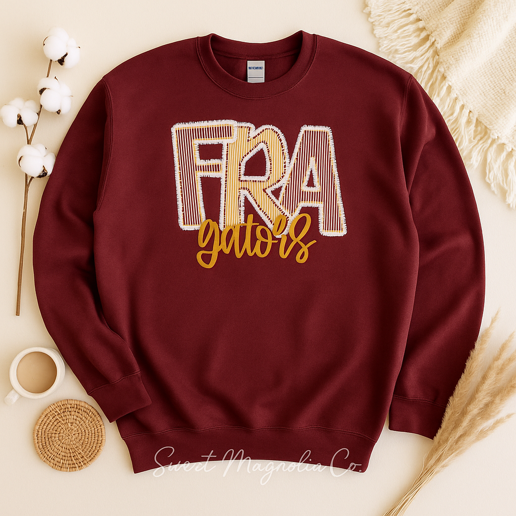 Maroon sweatshirt with 'FRA Gators' text on a neutral background