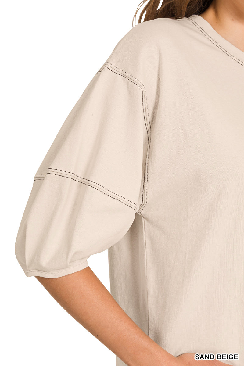 Close-up of a sand beige top with a plain background