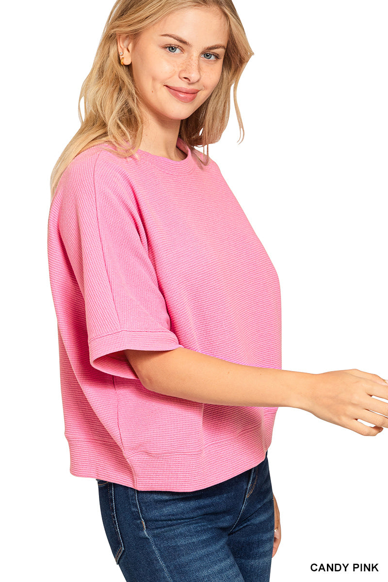 Woman wearing a pink top with a white background
