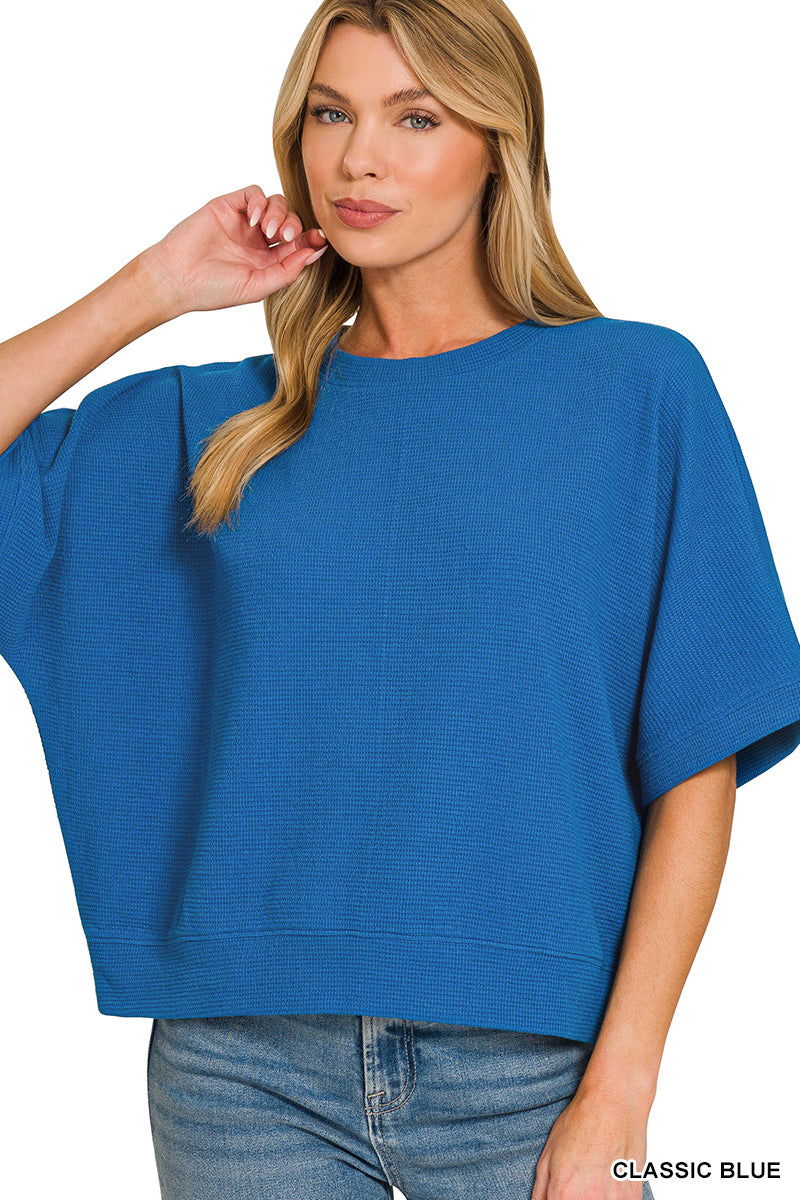 Woman wearing a blue top with a blurred background