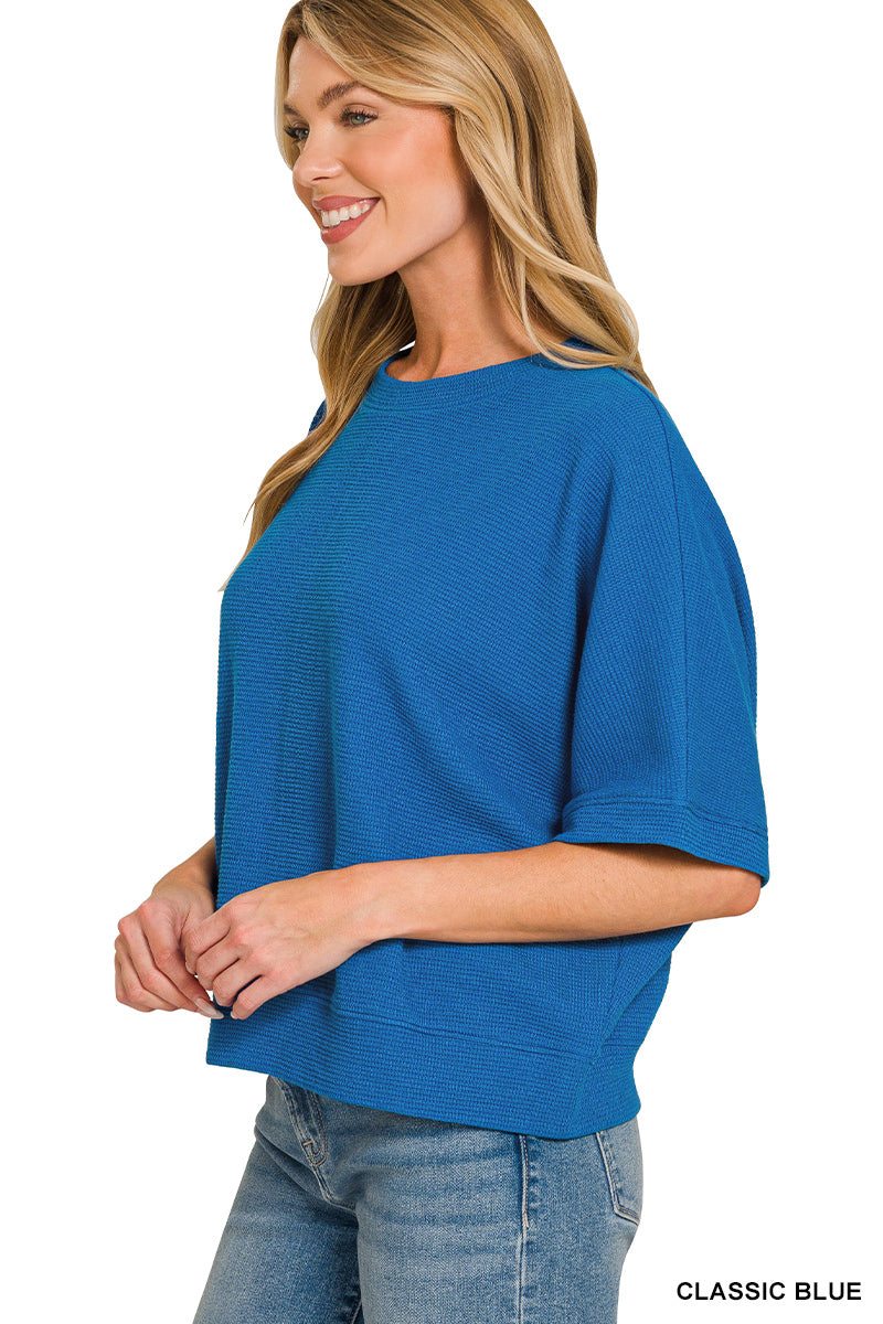 Woman wearing a blue top on a white background