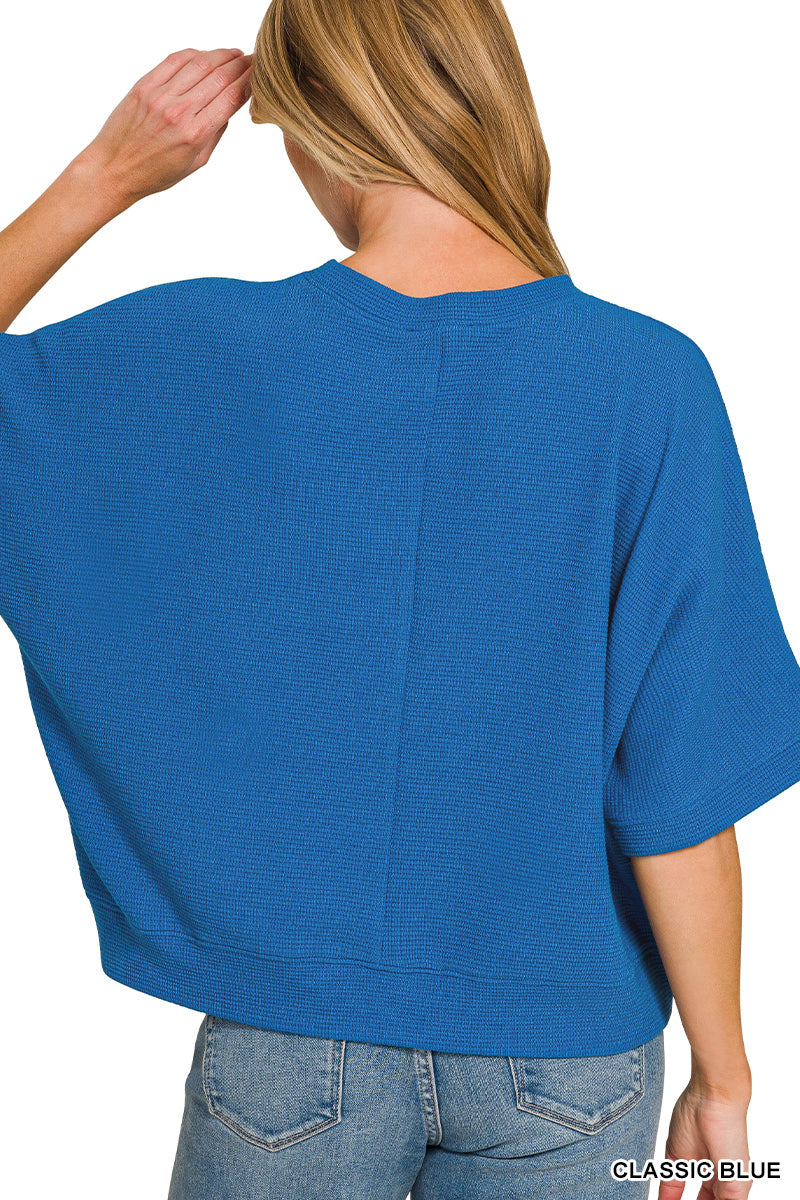 Person wearing a blue top on a white background