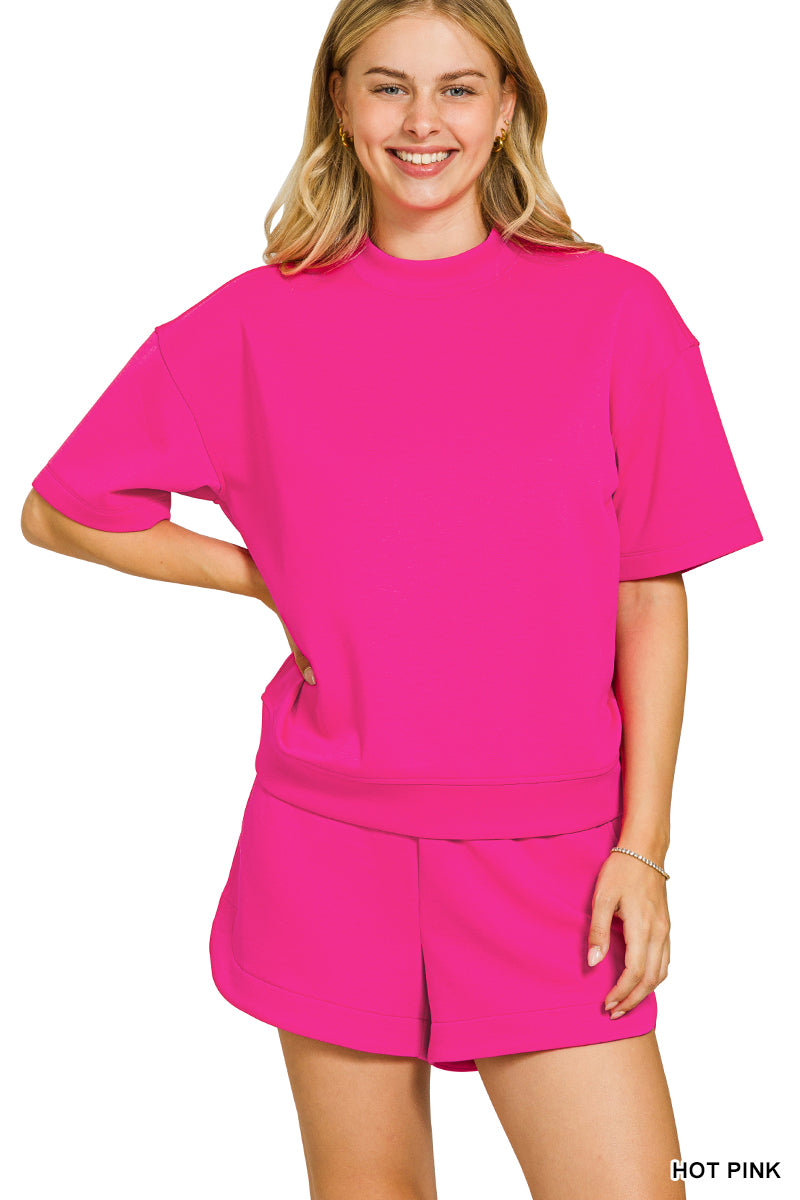 Woman wearing a bright pink outfit on a white background