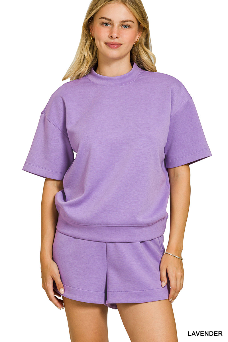 Woman wearing a lavender outfit on a white background