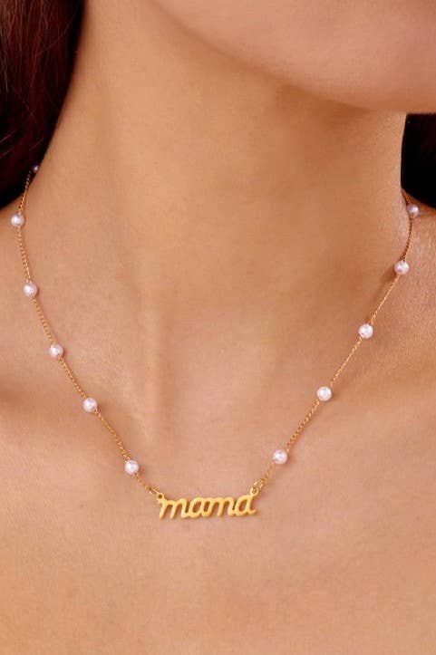 Gold 'mama' necklace with pearl accents on a person's neck